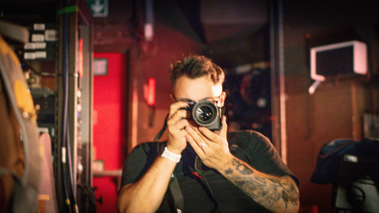 Professional photographer and videographer capturing photos during indoor shoot